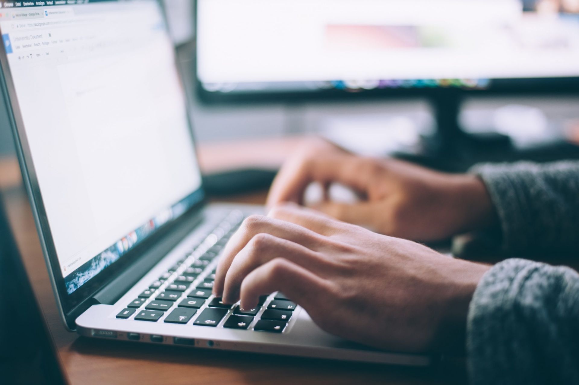 A Person Is Typing On A Laptop That Is Open To A Google Page