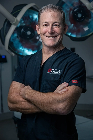 Dr. Justin Field Wearing A Black Scrub That Says DISC On It